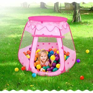 A girl playing in the pink tent with balls
