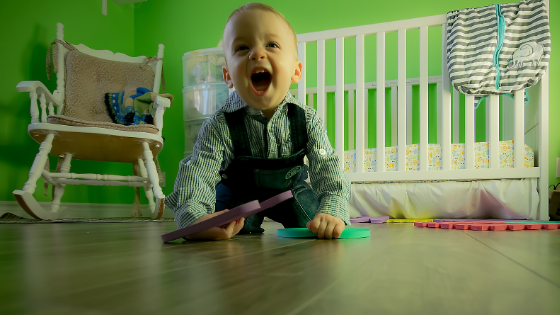 a toddler boy playing on the ground