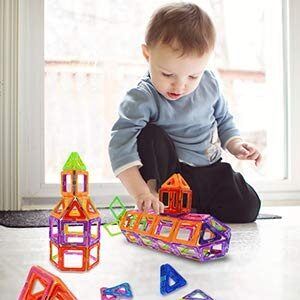 A toddler boy playing blocks