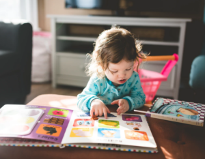 Toddler girl reading books
