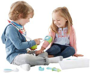 a boy and a girl pretend play doctor