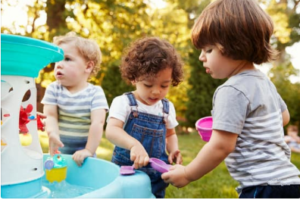 3 toddlers playing with water tables